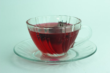 Glass of cold roselle juice - healthy food against wood