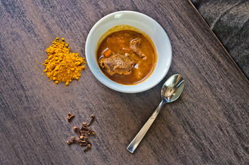 cup of steaming hot soup with spices
