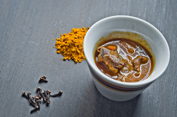 cup of steaming hot soup with spices