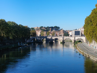 Fototapeta na wymiar Tiber river and Bridge of Holy Angel in Rome