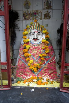 Hindu street shrine, decorated with marigold mala (garlands) for Diwali festival, Udaipur, Rajasthan