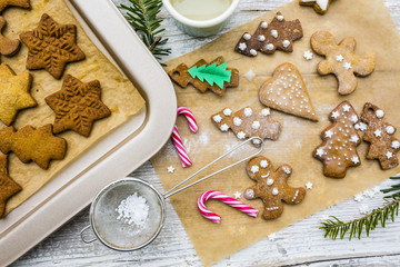 Christmas homemade gingerbreads and Christmas spices on a wooden background. 
