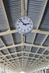 clock mobile on ceiling train station platform