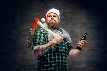 A man in Santa's hat drinking beer.