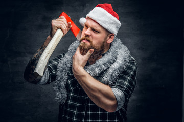 Bearded male in Santa's hat holds the axe.
