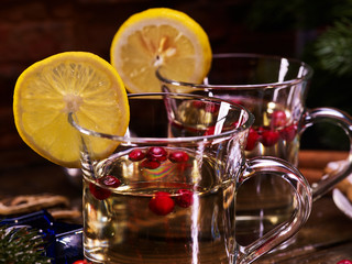 Two romantic Christmas cup of hot tea and wine decoration lemon slice close-up.