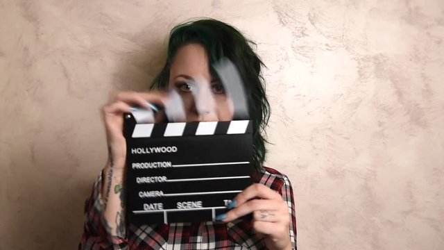 Young woman actress using movie clapper board audition