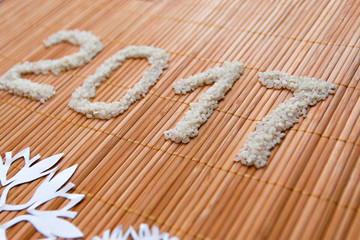 Christmas and New Year composition of rice and snowflakes on mat