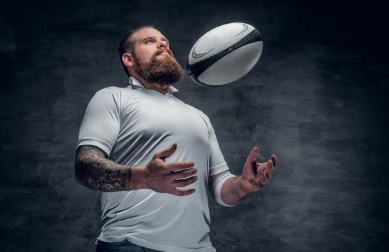 The bearded rugby player catching a game ball.