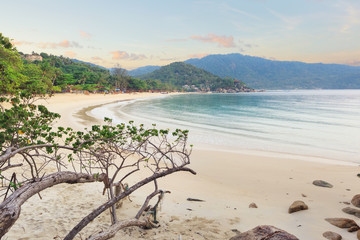 Empty morning Samui beach with beach rocks on foreground