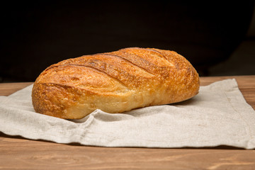 Fresh loaf of bread and a butter knife