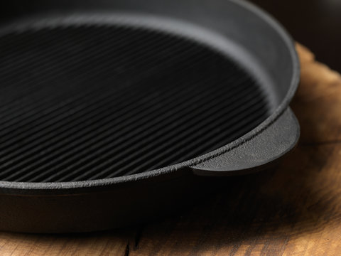 Cast-iron pan. On a wooden stand.
