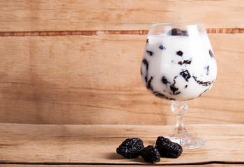 Desserts with prune, walnut and sour cream in vase. 