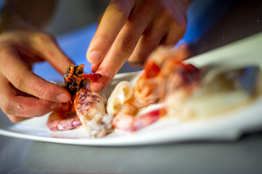 Chef arranging a prawn based dish