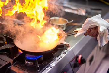 Chef cooking in flames