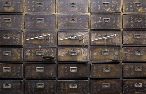 Old wooden drawers and scales in a Chinese pharmacy in  Melaka (Malacca), Malaysia