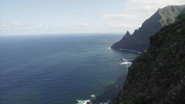 Scenic footage of dramatic and dangerous rocky cliffs jagged to ocean. Tenerife, Canary Islands, Spain.