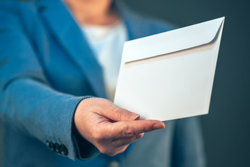 Business woman offering white envelope as bribe - obrazy, fototapety, plakaty