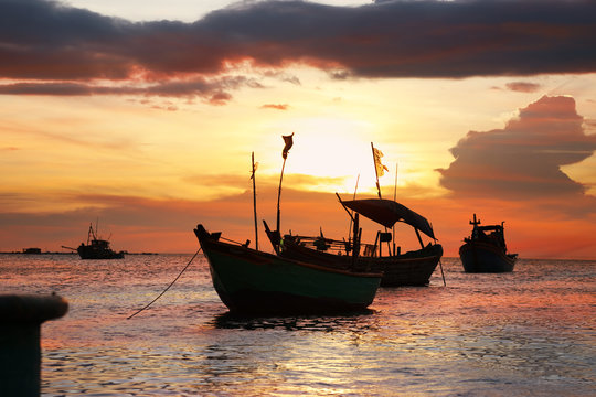 Silhouettes of anchored fishing boats