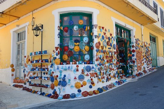 Pottery displayed on the wall of a shop in the village centre, Margarites, Crete.
