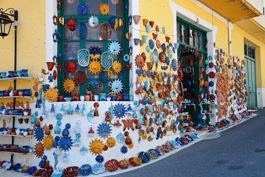 Pottery displayed on the wall of a shop in the village centre, Margarites, Crete.