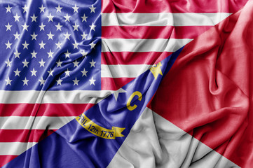 Ruffled waving United States of America and North Carolina flag