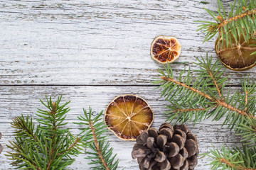 Christmas fir branches with cones and dry lemon slice