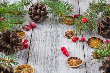 Obraz na płótnie Canvas Christmas branches with cones viburnum berries and dry lemon slice
