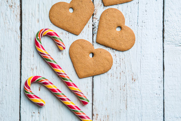 Christmas backgrounds. Christmas decor on wooden background with cookies and cane.