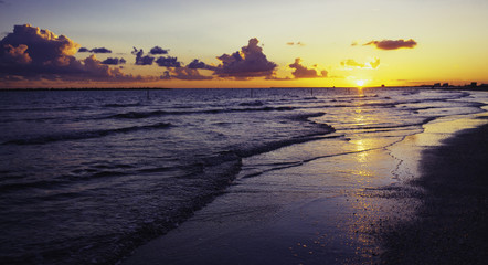 Fototapeta na wymiar Vintage sunset over sea waves, Cloudy orange sunset over sea wat