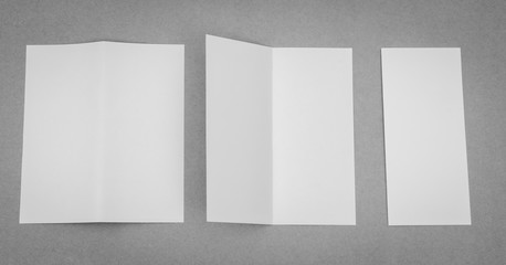 Bifold white template paper on gray background .