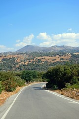 Country road leading towards the mountains near Margarites, Crete.