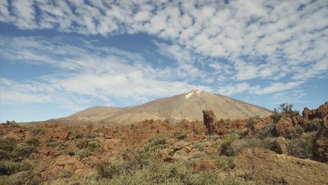 Hiking in Teide National Park. Footage of dramatic volcanic landscape with majetic Teide volcano in a background, Tenerife, Canary Islands, Spain.