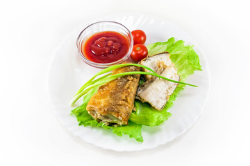 fried hake with tomatoes and green onion