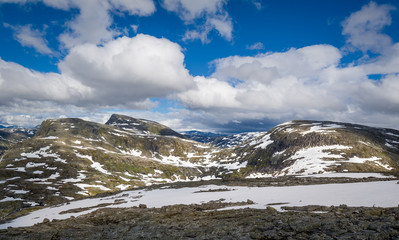 Fototapeta na wymiar Rocks and snow in the mountains of Geiranger fjord, Norway.