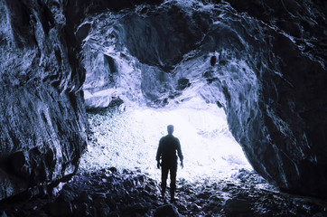 man at cave entrance