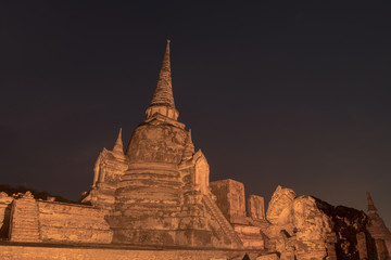 Fototapeta premium Ancient ruins of the temple Wat Phra Sri Sanphet national historic site with lights show at twilight time in Ayutthaya, Thailand.