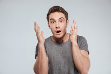Portrait of a man holding hands at his face