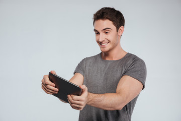 Portrait of a smiling happy man using tablet computer