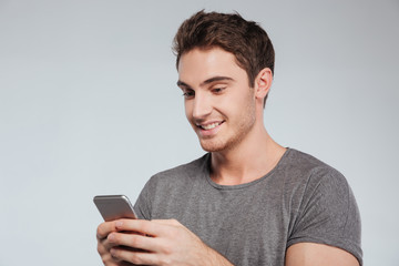 Close-up portrait of an attractive man using mobile phone
