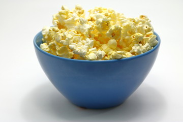 popcorn in blue bowl on white background