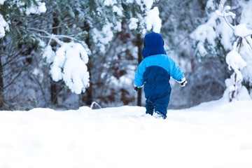 Happy caucasian child playing in snow