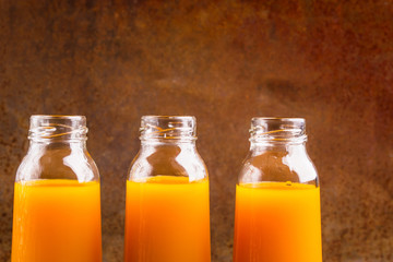 Fresh pressed juice of pumpkin in a glass transparent bottle clo