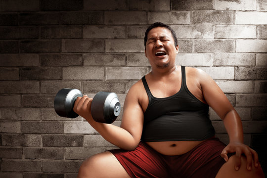 Fat man lifting weights