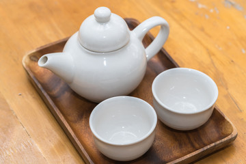 White teapot with a mug
