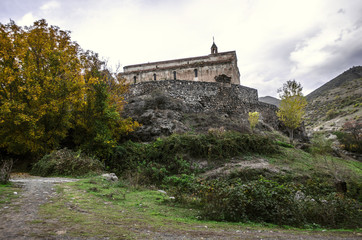 Fototapeta na wymiar View of the medieval monastery Tsitsernavank in the autumn overcast day