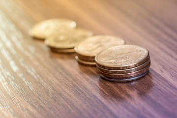 one dollar coin on wooden desk