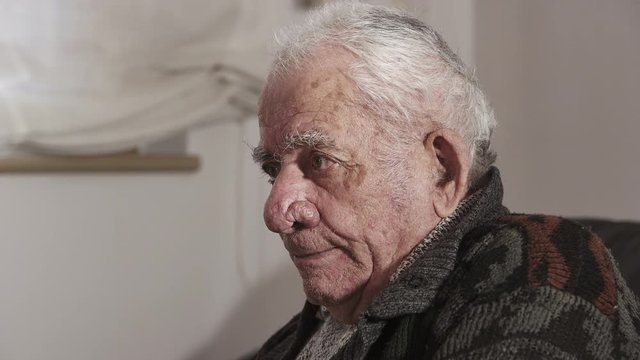 Old man crying alone in his home