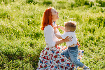 beautiful mother with her son in summer park