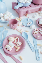 Colorful plastic tableware and marshmallows